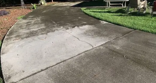 Before photo of dirty concrete driveway before pressure washing in Winder Georgia
